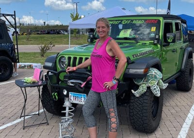 2021 Award Winner woman with Green Metallic colored Jeep