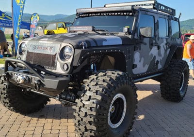 Gray and white camo Jeep on display